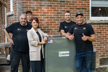Group of people posing with an air conditioning
