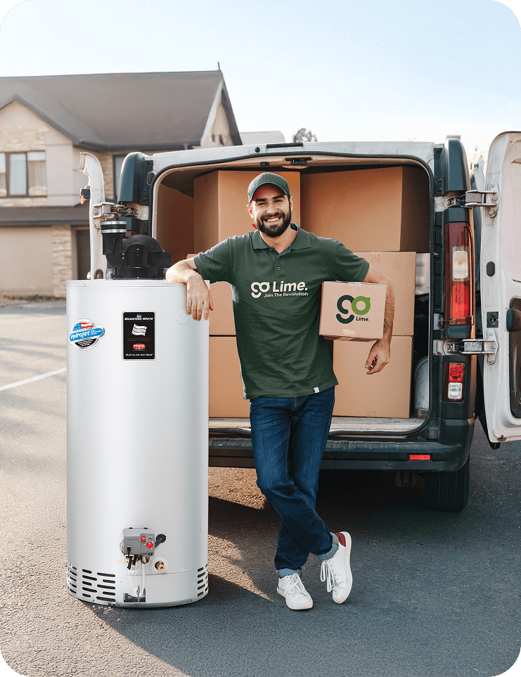 Man in a green 'Go Lime' shirt leaning against a large white cylindrical 