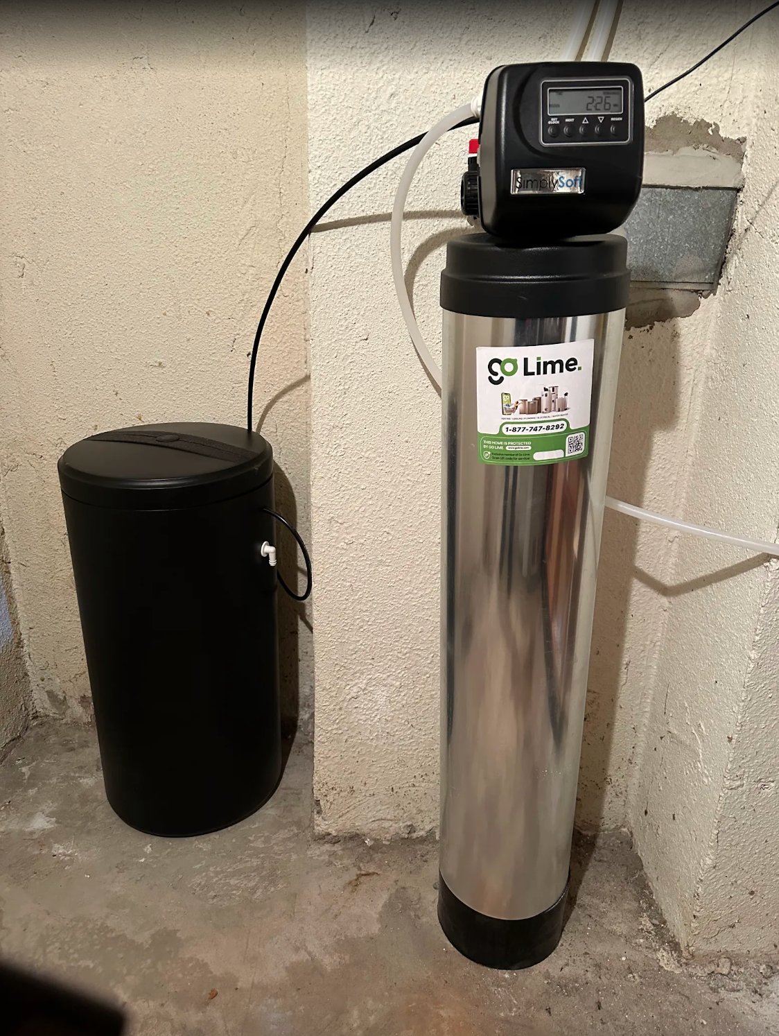 Spa or pool water filtration system with a digital timer against a concrete wall