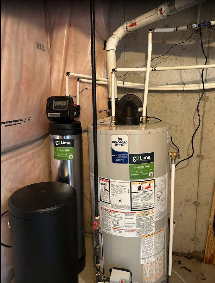 Water heater with pipes and a control panel in a basement setting