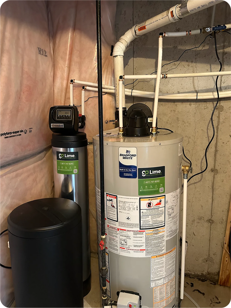 Water heater with pipes and a black cylindrical object