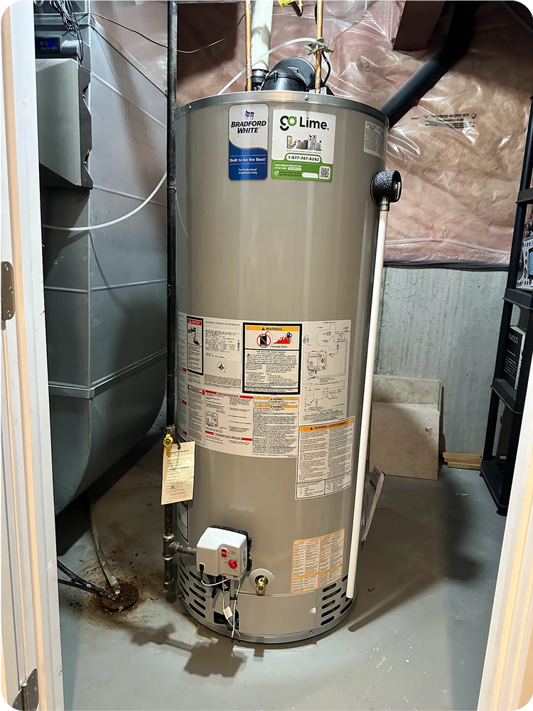 Water heater in a room with insulation and pipes visible